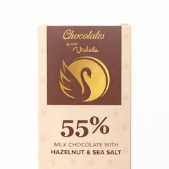 Chocolates by Cafe Vishala milk chocolate bar packaging with hazelnut and sea salt flavor on a white background.