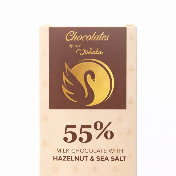 Chocolates by Cafe Vishala milk chocolate bar packaging with hazelnut and sea salt flavor on a white background.